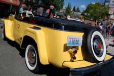 Photo of 1949 Willys Overland Jeepster shows rear end, rear fenders and convertible top boot