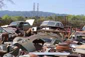 Antique project cars piled and stored in classic car junk yard