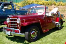 Great red metallic paint job on a restored 1950 Willys Overland Jeepster