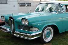 Chrome gun sight hood ornament and deep inset front grille panels on a 1958 Edsel Station Wagon