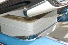 Luggage bin and restored hydraulic mechanisms in the trunk of a 1959 Ford Galaxie Skyliner