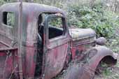 Very unique vintage pickup truck stored in old car junkyard