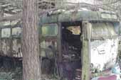 Unique vintage passenger bus stored in classic car junk yard