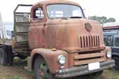 Awesome old cab-over truck stored in vintage truck salvage yard